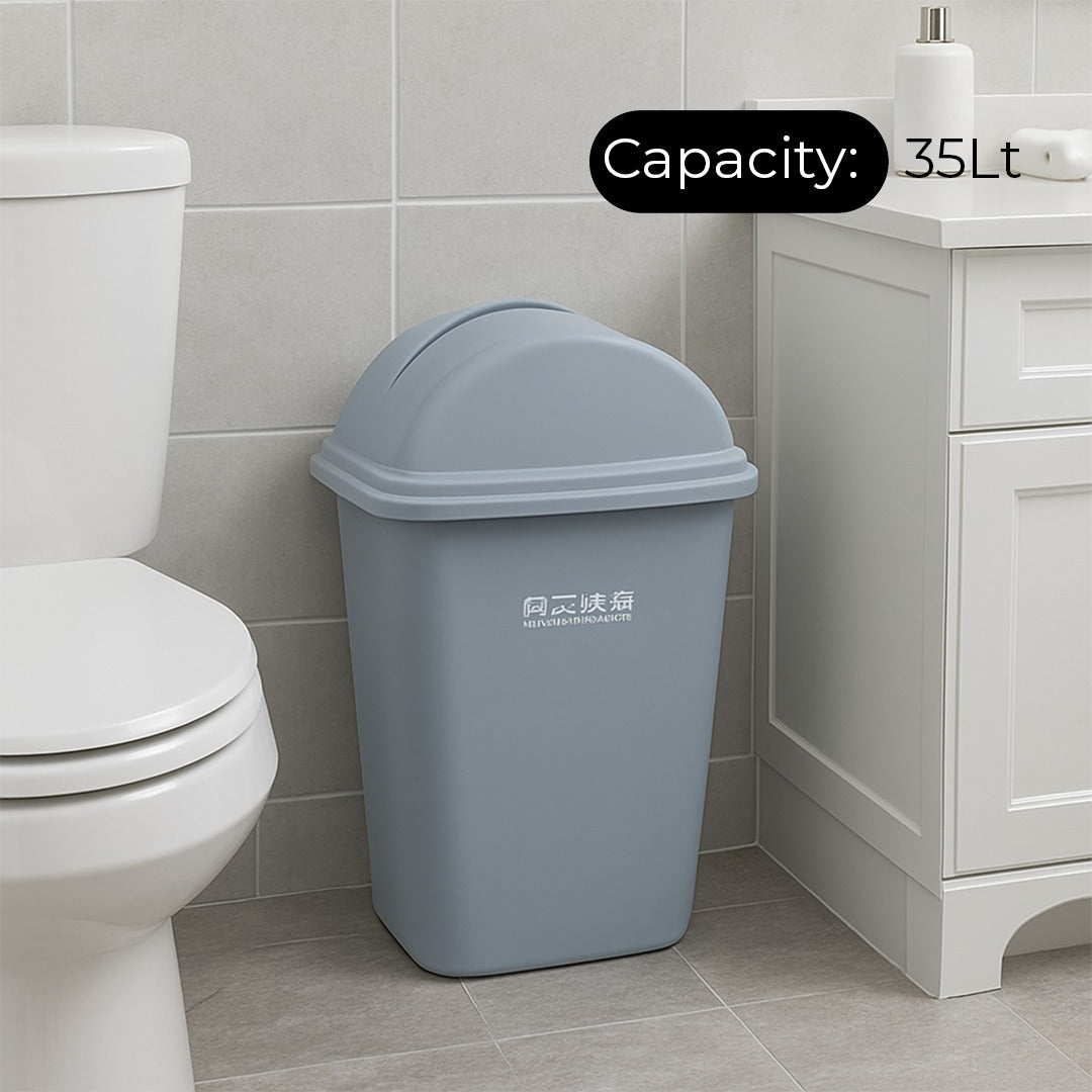 Gray trash bin with capacity label in a bathroom setting