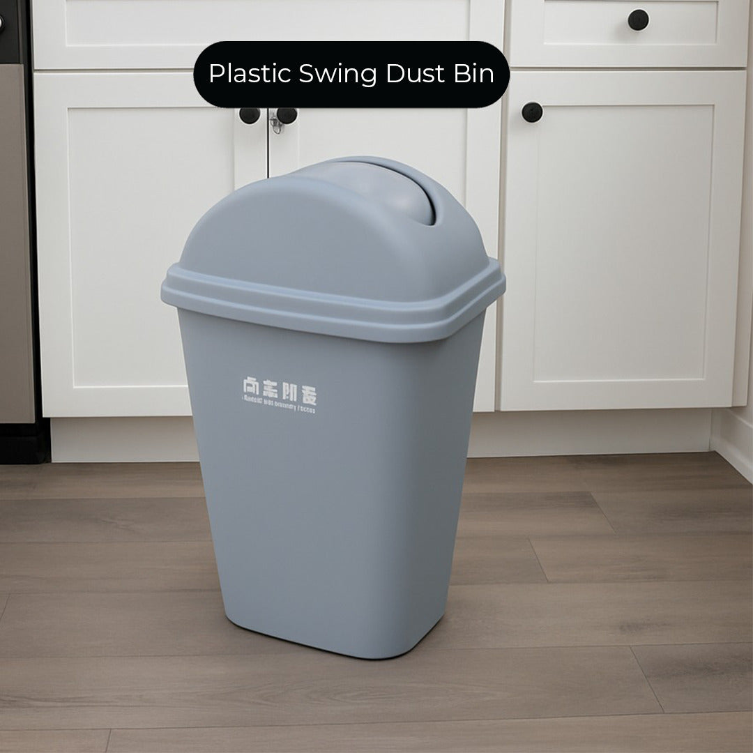 Gray plastic swing dust bin in a kitchen setting