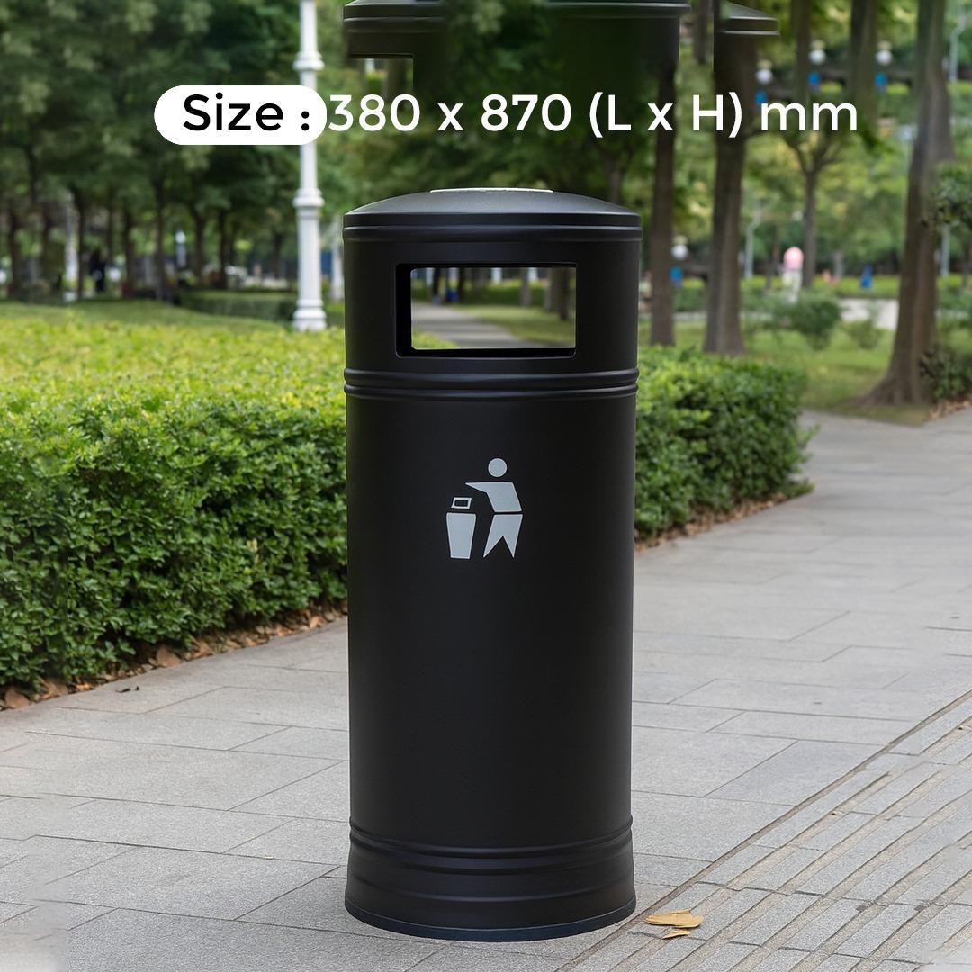 Black cylindrical trash bin with a size label on a park pathway
