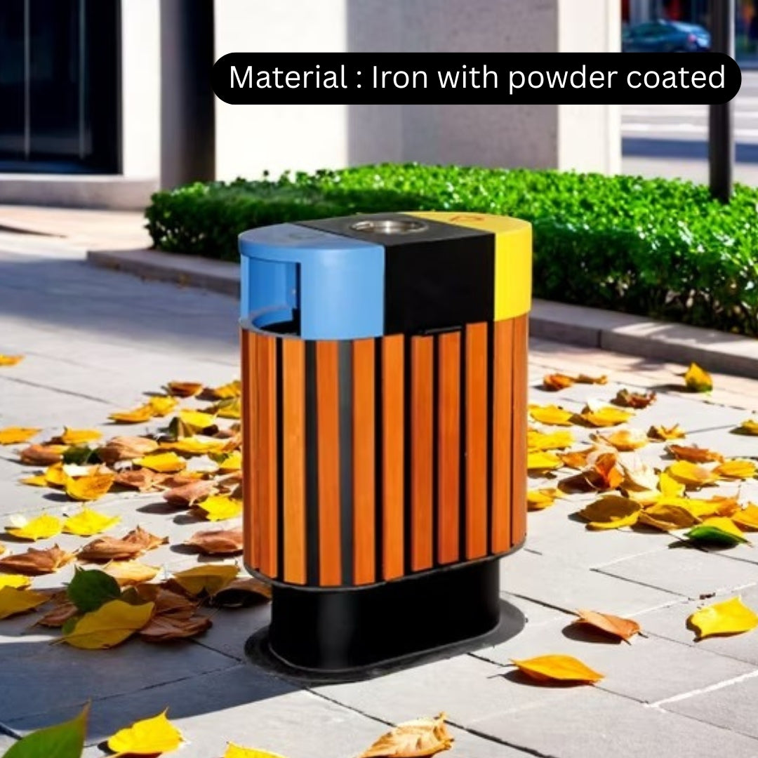 Multicolored trash can with powder-coated finish on a sidewalk with fallen leaves.